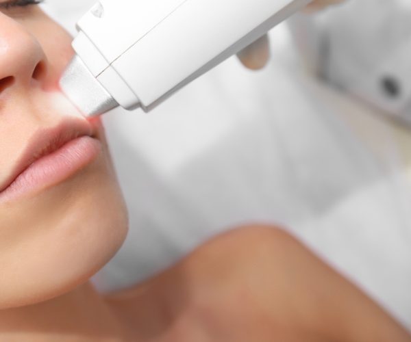 Woman on laser hair removal procedure at beauty salon. Epilation concept